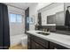 Elegant bathroom with dark vanity, black tile, and a white countertop at 3105 N 21St St, Phoenix, AZ 85016