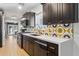 Modern kitchen with dark cabinetry, quartz countertops and geometric backsplash at 3105 N 21St St, Phoenix, AZ 85016