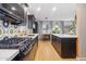 Modern kitchen with dark cabinetry, quartz countertops and geometric backsplash at 3105 N 21St St, Phoenix, AZ 85016