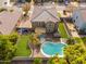 Aerial view of a two-story home with a pool and lush landscaping at 3552 E Claxton Ave, Gilbert, AZ 85297