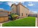 Landscaped backyard with lush green grass and a two-story home at 3552 E Claxton Ave, Gilbert, AZ 85297