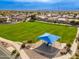 Expansive grassy area with shaded playground and seating at 3552 E Claxton Ave, Gilbert, AZ 85297