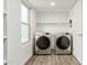 Laundry room with washer, dryer, and shelving at 3552 E Claxton Ave, Gilbert, AZ 85297