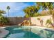 Relaxing kidney-shaped pool with a waterfall feature and lush landscaping at 3552 E Claxton Ave, Gilbert, AZ 85297