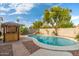 Inviting kidney-shaped pool with a waterfall feature and a tiki bar at 3552 E Claxton Ave, Gilbert, AZ 85297