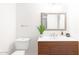 Modern bathroom with wood vanity, frameless mirror, and updated fixtures at 3810 E Shea Blvd, Phoenix, AZ 85028