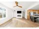 Open living room with wood floors, fireplace and kitchen island view at 3810 E Shea Blvd, Phoenix, AZ 85028