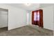 Simple bedroom with carpet, closet, and window with curtains at 3821 W Verde Ln, Phoenix, AZ 85019