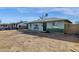 Ranch style home with a large front yard and a green brick facade at 3821 W Verde Ln, Phoenix, AZ 85019