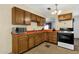 Bright kitchen features wood cabinets,orange countertops, and a microwave at 3821 W Verde Ln, Phoenix, AZ 85019