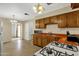 Kitchen with wood cabinets, orange countertops and gas stove at 3821 W Verde Ln, Phoenix, AZ 85019