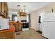 View of kitchen with white appliances and wood cabinets at 3821 W Verde Ln, Phoenix, AZ 85019