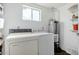 Laundry room with washer, dryer, water heater and shelving at 3821 W Verde Ln, Phoenix, AZ 85019