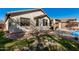 Home features a grassy backyard with a paved patio, putting green, and swimming pool at 4795 E Bellerive Dr, Chandler, AZ 85249