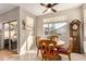 Bright breakfast nook with a round table, four chairs, and a grandfather clock at 4795 E Bellerive Dr, Chandler, AZ 85249