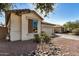 Tan house with a two-car garage and a nicely landscaped yard at 4795 E Bellerive Dr, Chandler, AZ 85249