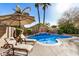 Relaxing pool area with lounge chairs and an umbrella, perfect for entertaining at 4795 E Bellerive Dr, Chandler, AZ 85249