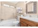 Bathroom with a bathtub, white toilet, and modern mirror at 5121 W Jupiter Way, Chandler, AZ 85226