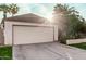 Two car garage with driveway and landscaping at 5121 W Jupiter Way, Chandler, AZ 85226