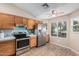 Bright kitchen with stainless steel refrigerator, ceiling fan, and natural light at 5121 W Jupiter Way, Chandler, AZ 85226