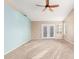 Open living room with neutral paint, a ceiling fan, and French doors at 5121 W Jupiter Way, Chandler, AZ 85226