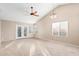 Bright living room featuring a ceiling fan and French doors at 5121 W Jupiter Way, Chandler, AZ 85226