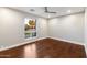 Well-lit bedroom featuring hardwood floors and a window at 5429 E Bloomfield Rd, Scottsdale, AZ 85254