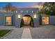 Inviting entryway with arched doorway, stylish lighting, and landscaping at 5429 E Bloomfield Rd, Scottsdale, AZ 85254