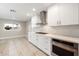 Sleek kitchen with white cabinetry, stainless steel appliances, and mosaic backsplash at 5429 E Bloomfield Rd, Scottsdale, AZ 85254