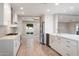 Modern kitchen with white cabinets, stainless steel appliances, and a large island at 5429 E Bloomfield Rd, Scottsdale, AZ 85254