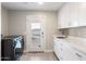 Bright laundry room with washer, dryer, and ample counter space at 5429 E Bloomfield Rd, Scottsdale, AZ 85254