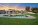 Relaxing kidney-shaped pool with grassy area at 5429 E Bloomfield Rd, Scottsdale, AZ 85254