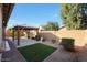 Landscaped backyard with artificial turf and gazebo at 5450 W Taro Ln, Glendale, AZ 85308