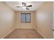 Well-lit bedroom with carpeted floor and ceiling fan at 5450 W Taro Ln, Glendale, AZ 85308