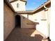 Charming courtyard entry with a brick paved floor and arched entryway at 5450 W Taro Ln, Glendale, AZ 85308