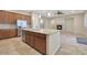 Spacious kitchen with an island and views into the Gathering room at 5450 W Taro Ln, Glendale, AZ 85308