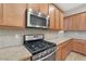 Modern kitchen with gas cooktop and stainless steel appliances at 5450 W Taro Ln, Glendale, AZ 85308