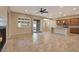 Open living room with tile flooring and views to kitchen and backyard at 5450 W Taro Ln, Glendale, AZ 85308