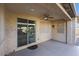 Covered patio with ceiling fan and sliding door at 5450 W Taro Ln, Glendale, AZ 85308