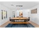 Elegant dining room with a long wooden table, bench seating, and hardwood floors at 5717 E Justine Rd, Scottsdale, AZ 85254