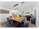 Open concept dining room with kitchen view, large wooden table, and modern light fixture at 5717 E Justine Rd, Scottsdale, AZ 85254