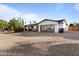 Contemporary home exterior featuring a sleek garage door and gravel driveway at 5717 E Justine Rd, Scottsdale, AZ 85254