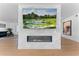 Modern fireplace with marble surround and large TV above at 5717 E Justine Rd, Scottsdale, AZ 85254