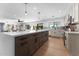 Modern kitchen with large island, wood cabinets, and quartz countertops at 5717 E Justine Rd, Scottsdale, AZ 85254