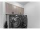 Convenient laundry room with Samsung washer and dryer, and upper cabinets at 5717 E Justine Rd, Scottsdale, AZ 85254