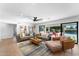 Bright living room with hardwood floors, sofas, and sliding glass doors to backyard at 5717 E Justine Rd, Scottsdale, AZ 85254