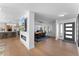 Open living and dining area with modern fireplace and kitchen at 5717 E Justine Rd, Scottsdale, AZ 85254