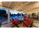 Relaxing covered patio with string lights and red adirondack chairs at 5717 E Justine Rd, Scottsdale, AZ 85254