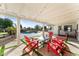 Relaxing patio area with red chairs and string lights, overlooking the pool at 5717 E Justine Rd, Scottsdale, AZ 85254