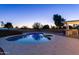 Inviting kidney-shaped pool with surrounding patio and outdoor kitchen at 5717 E Justine Rd, Scottsdale, AZ 85254